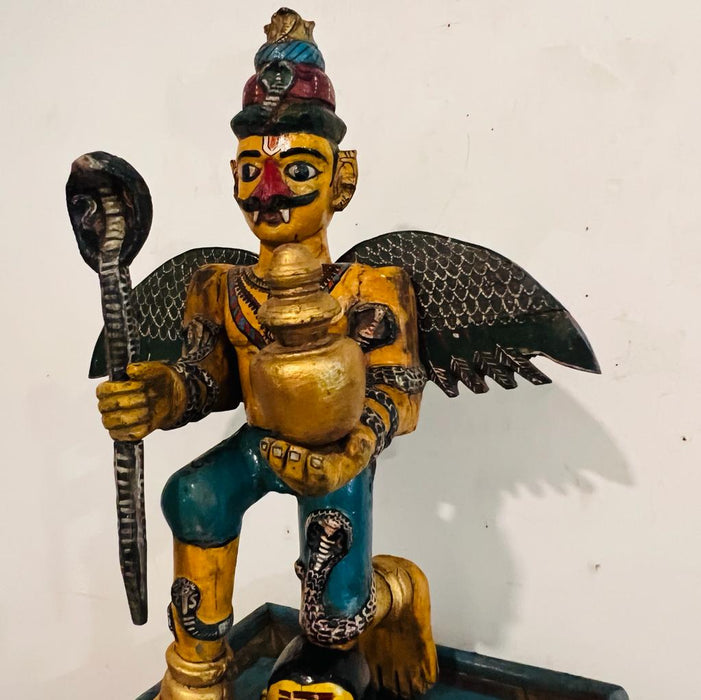 Garuda  : Handpainted Wooden Sculpture with unusual Colouring seated on a chowki (33 inches )