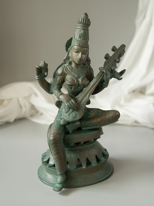 Maa Saraswati 
Brass Idol Sitting On Lotus Base