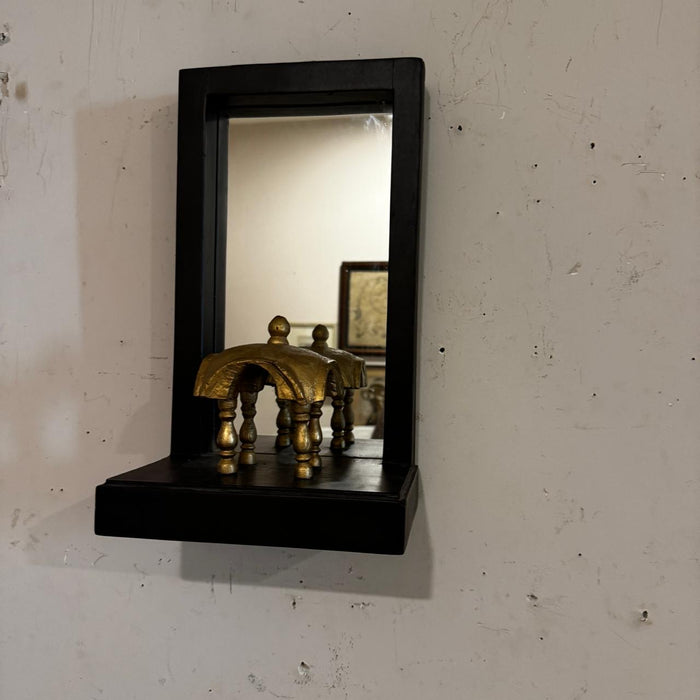Mirror with a gold defined element