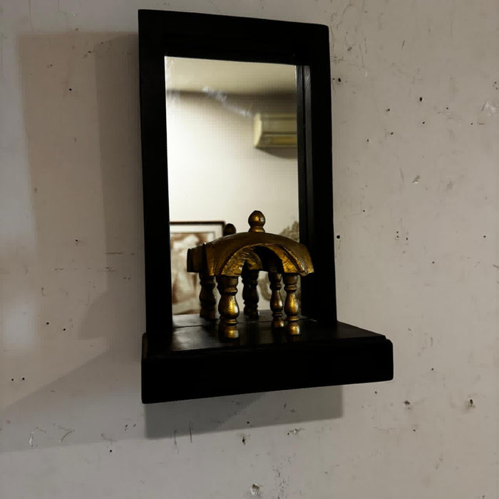 Mirror with a gold defined element