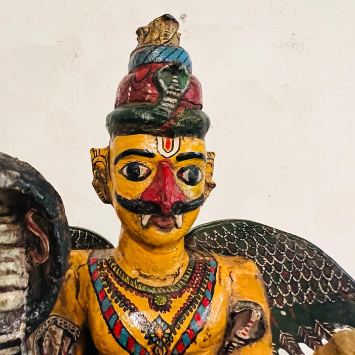 Garuda  : Handpainted Wooden Sculpture with unusual Colouring seated on a chowki (33 inches )
