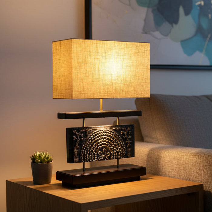 Table lamp with a gold shade and decorative base on a white background