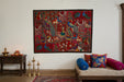 Colorful tapestry with intricate patterns and figures on a white wall